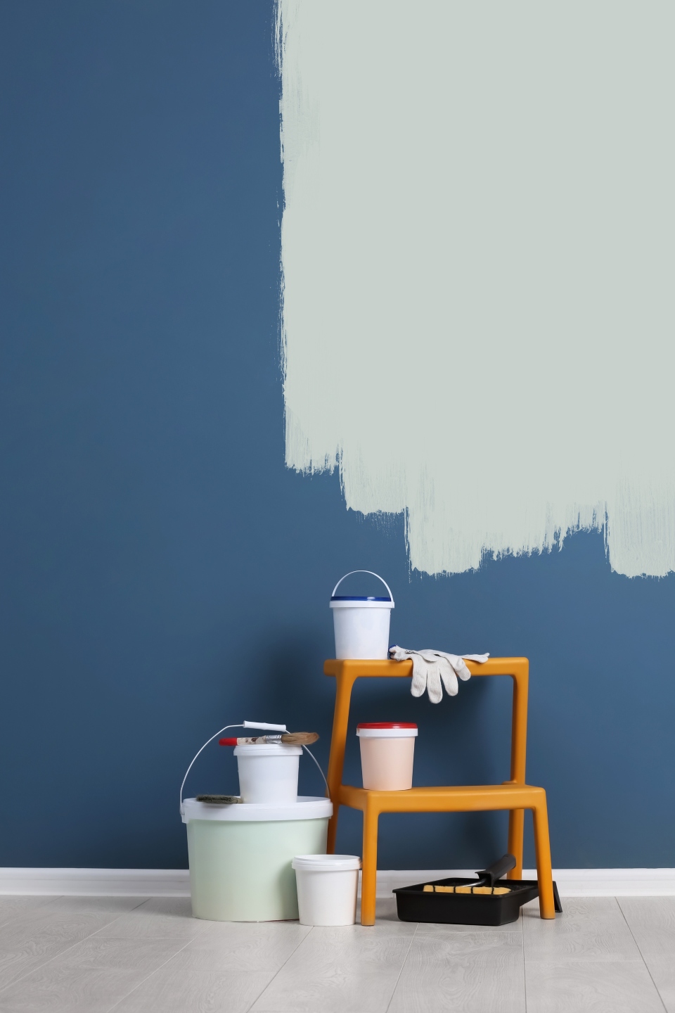 Paint supplies against blue wall